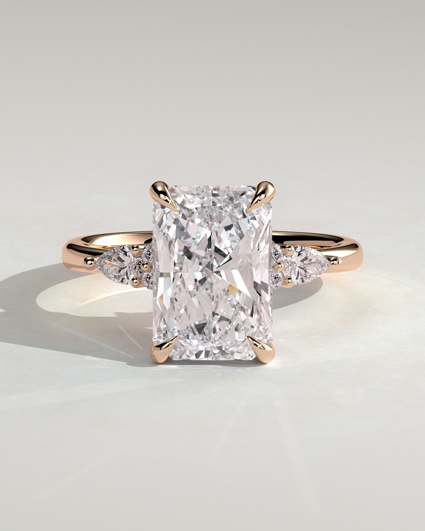 Heidi - Radiant Claw Solitaire with Pear Accents and Round Shoulder Stones Engagement Ring - Rose Gold