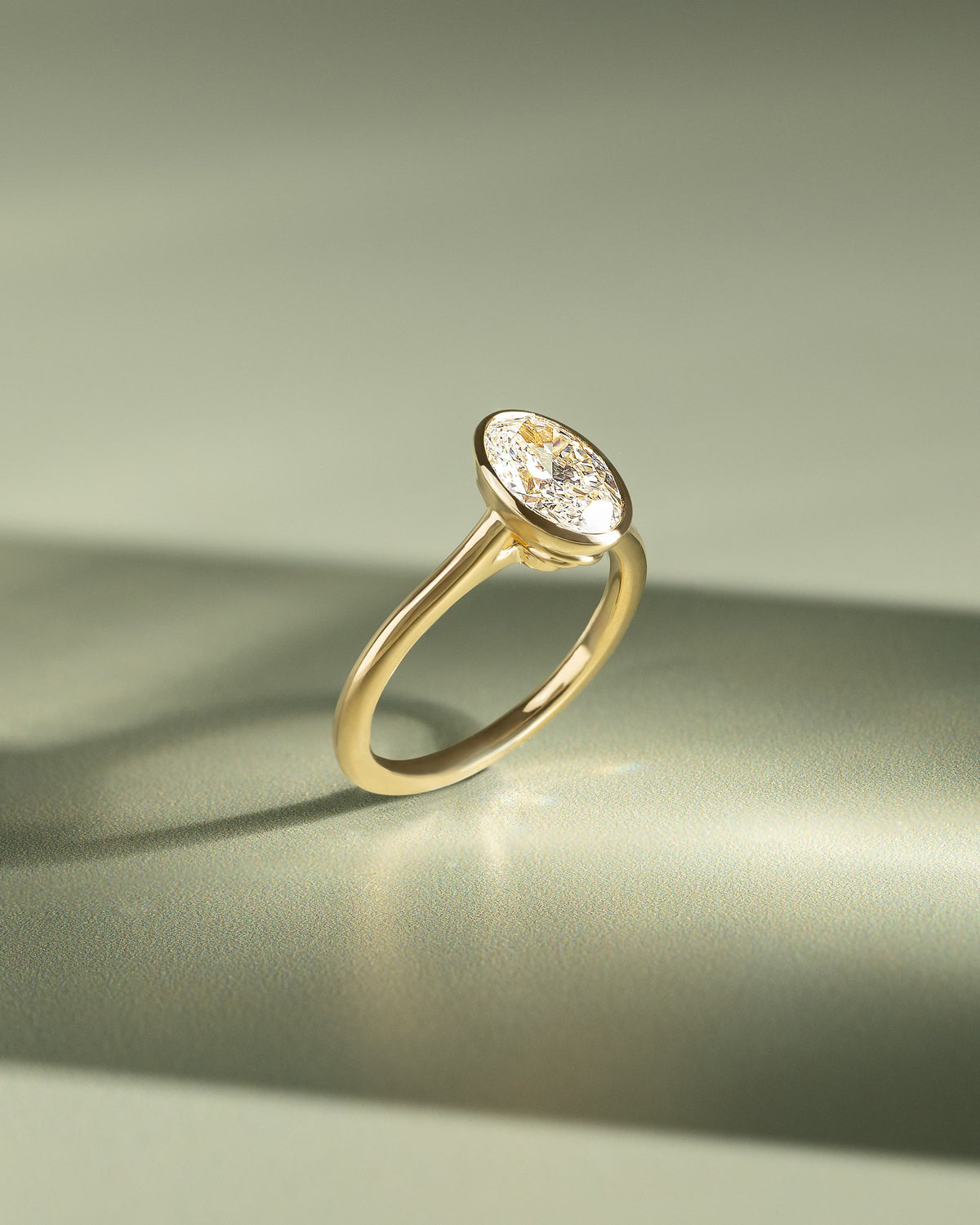 Gemma - Oval Bezel Solitaire with Twisted Gallery Engagement Ring - Yellow Gold