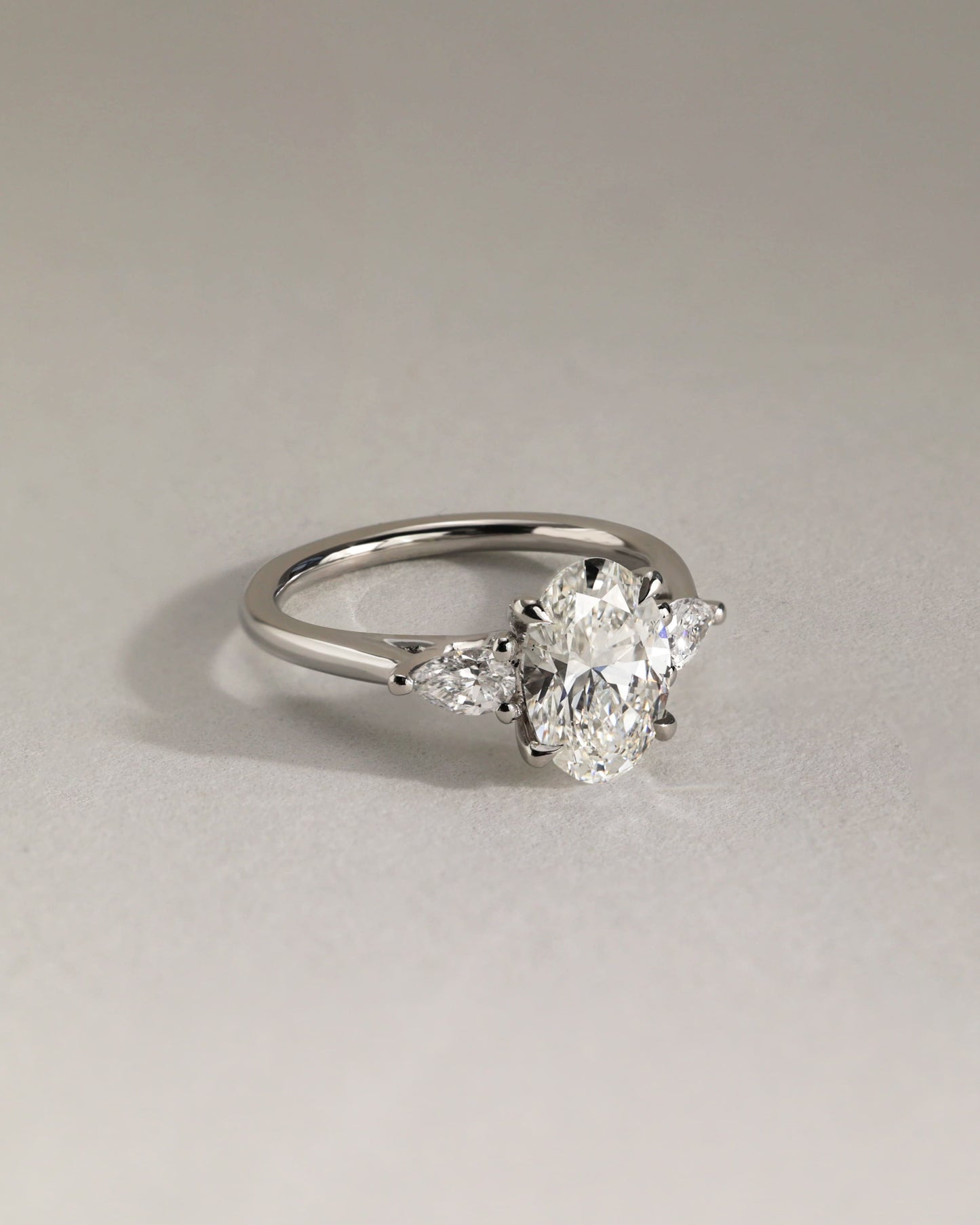 Amara - Oval Claw Trilogy with Pear Side Stones and Open Trellis Gallery Engagement Ring - Yellow Gold - yellow gold - Lara Jewels