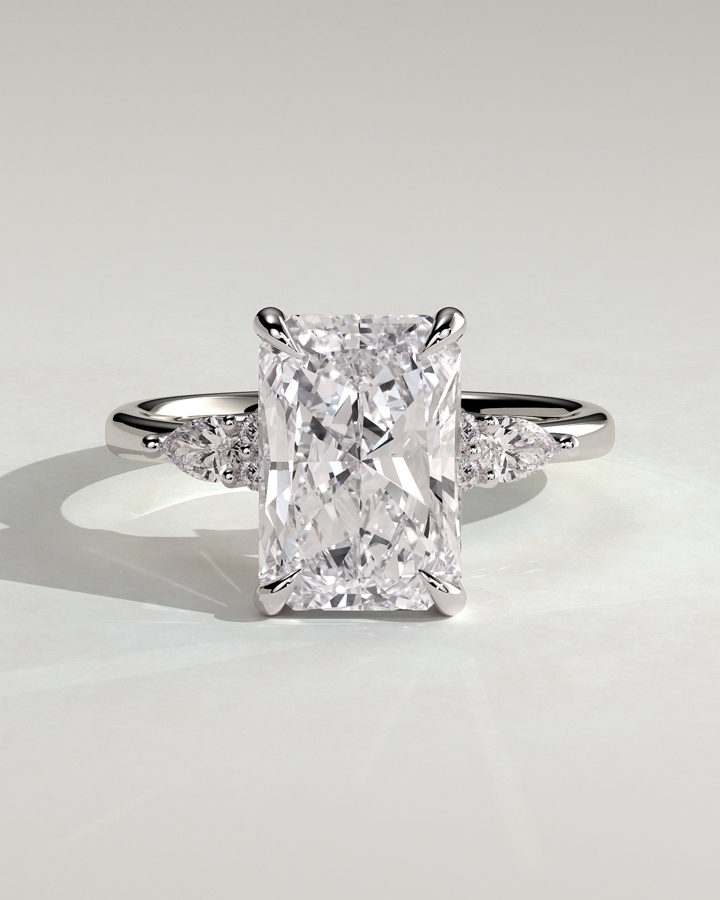 Heidi - Radiant Claw Solitaire with Pear Accents and Round Shoulder Stones Engagement Ring - Platinum