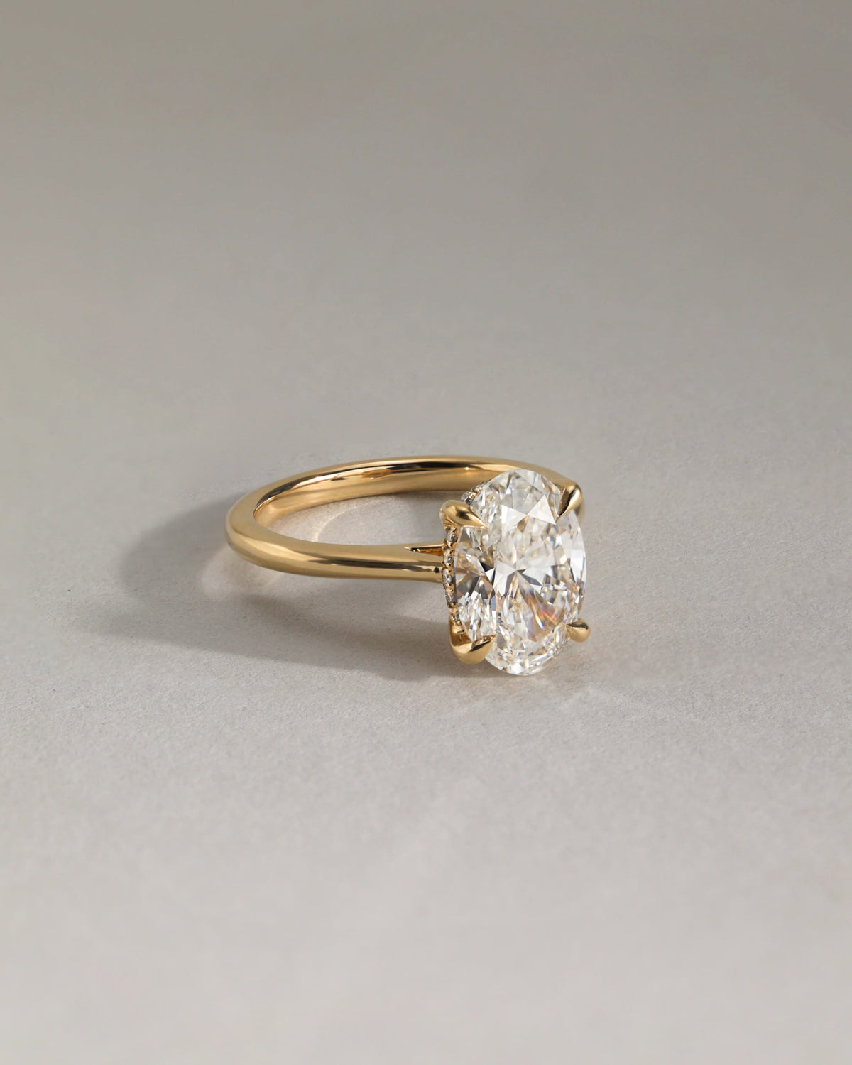 Bethany - Oval Claw Solitaire with Hidden Halo, Tapered Band and Cathedral High Setting Engagement Ring - Yellow Gold