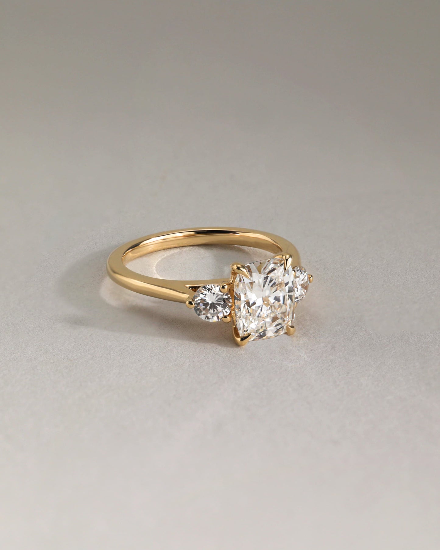 Charmaine - Elongated Cushion Claw Trilogy with Round Side Stones and Lily Detail Engagement Ring - Yellow Gold