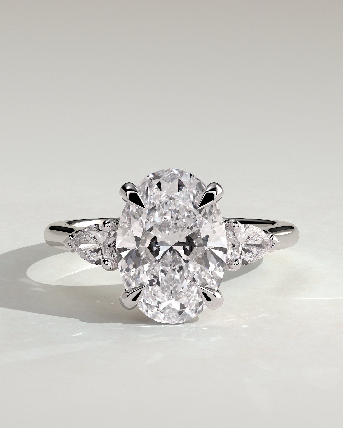 Alexia - Oval Claw Trilogy with Pear Side Stones and Cathedral Setting Engagement Ring - Platinum