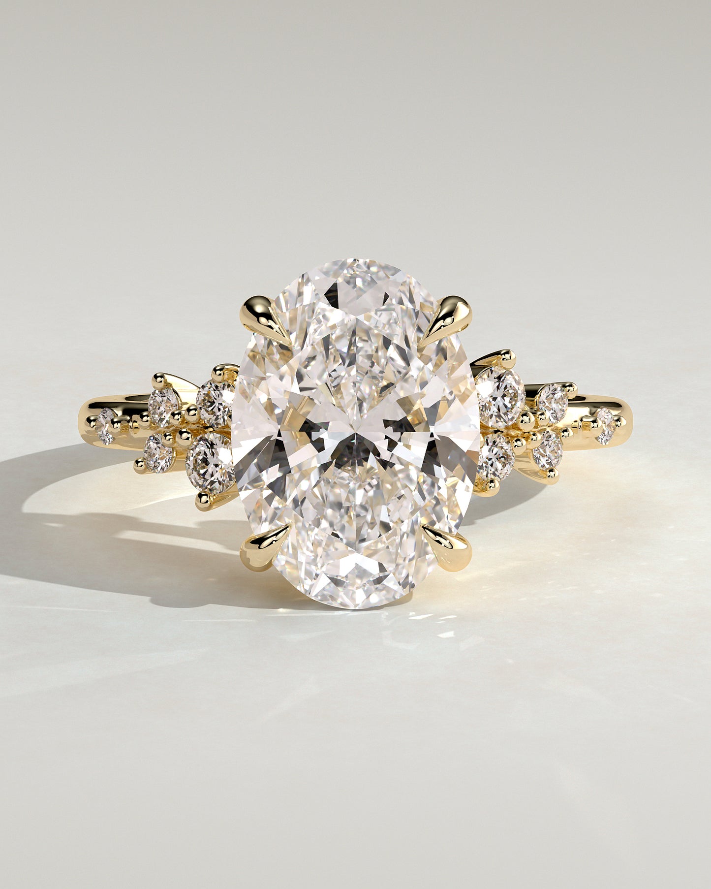 Bella - Oval Claw Solitaire with Clustered Round Shoulder Stones Engagement Ring - Yellow Gold