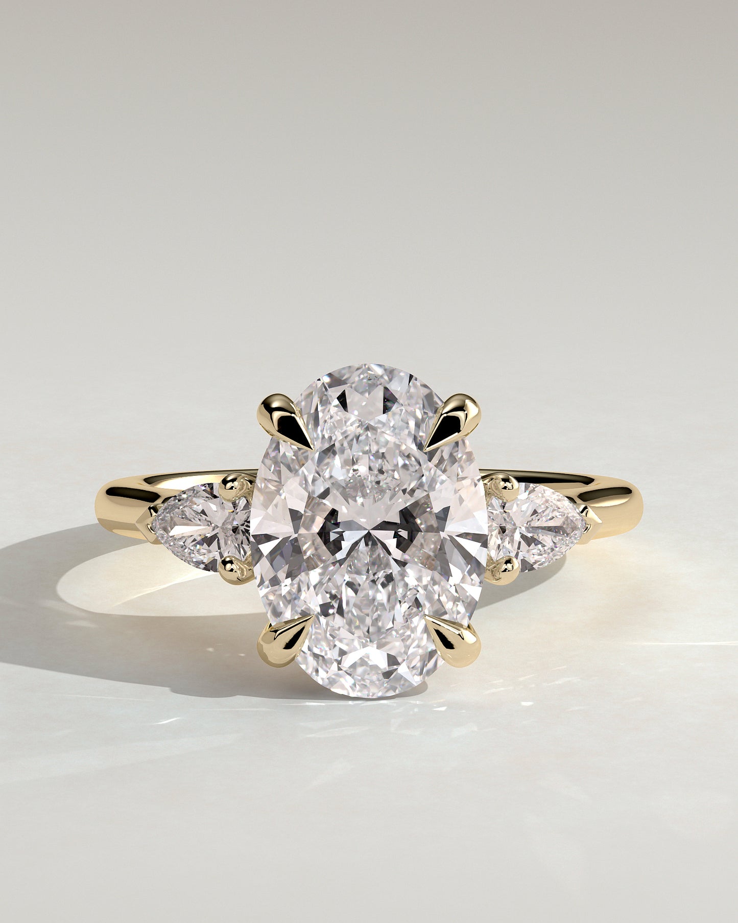Alexia - Oval Claw Trilogy with Pear Side Stones and Cathedral Setting Engagement Ring - Yellow Gold