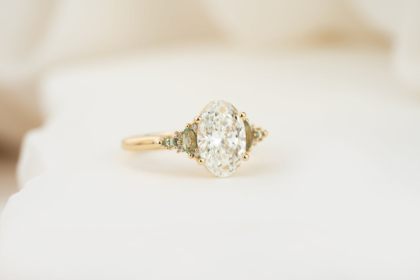 The Maeve Ring | 2.07 CT Oval Diamond + Light Green Sapphire Accents