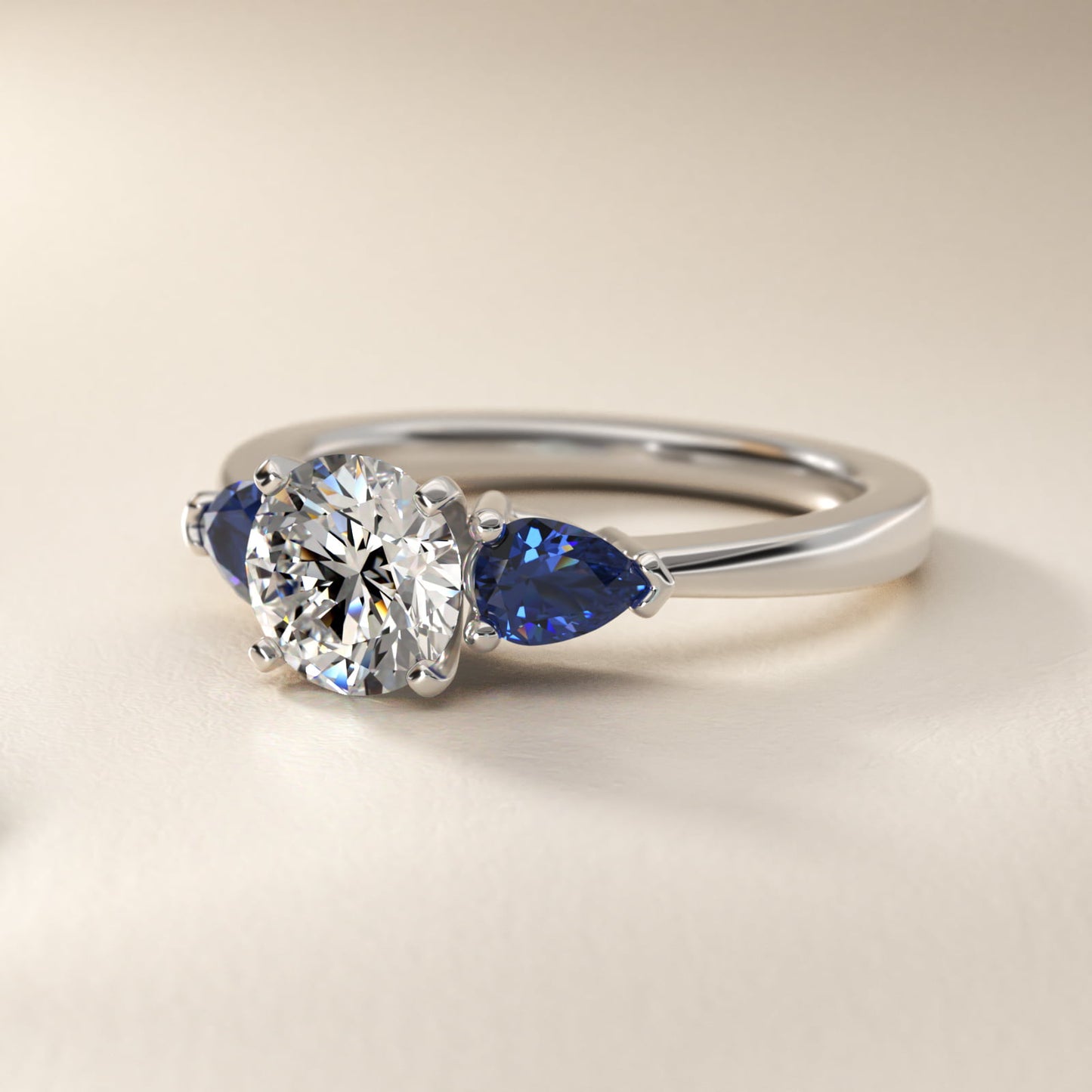 Classic Pear Shaped Sapphire Engagement Ring in Platinum - Round Center