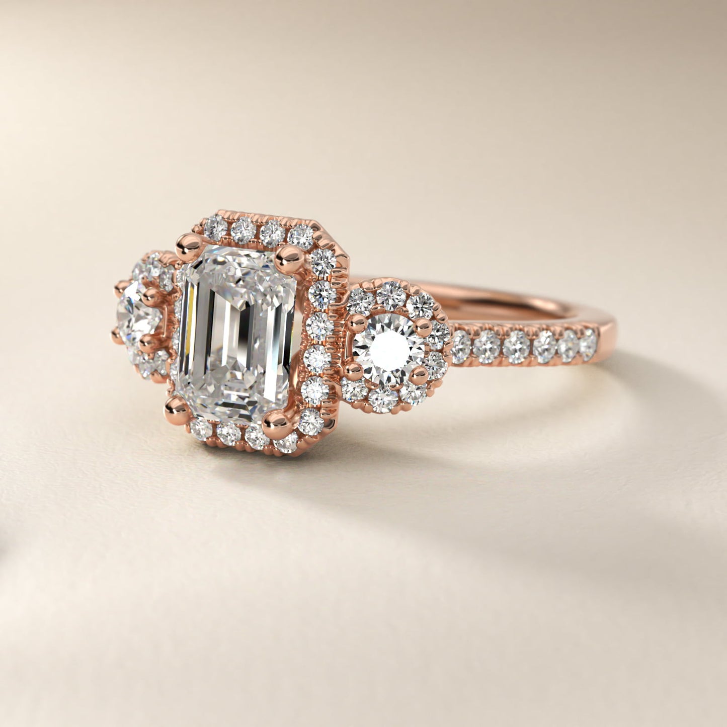 Three-Stone Halo Diamond Engagement Ring in 14k Rose Gold - Emerald Center