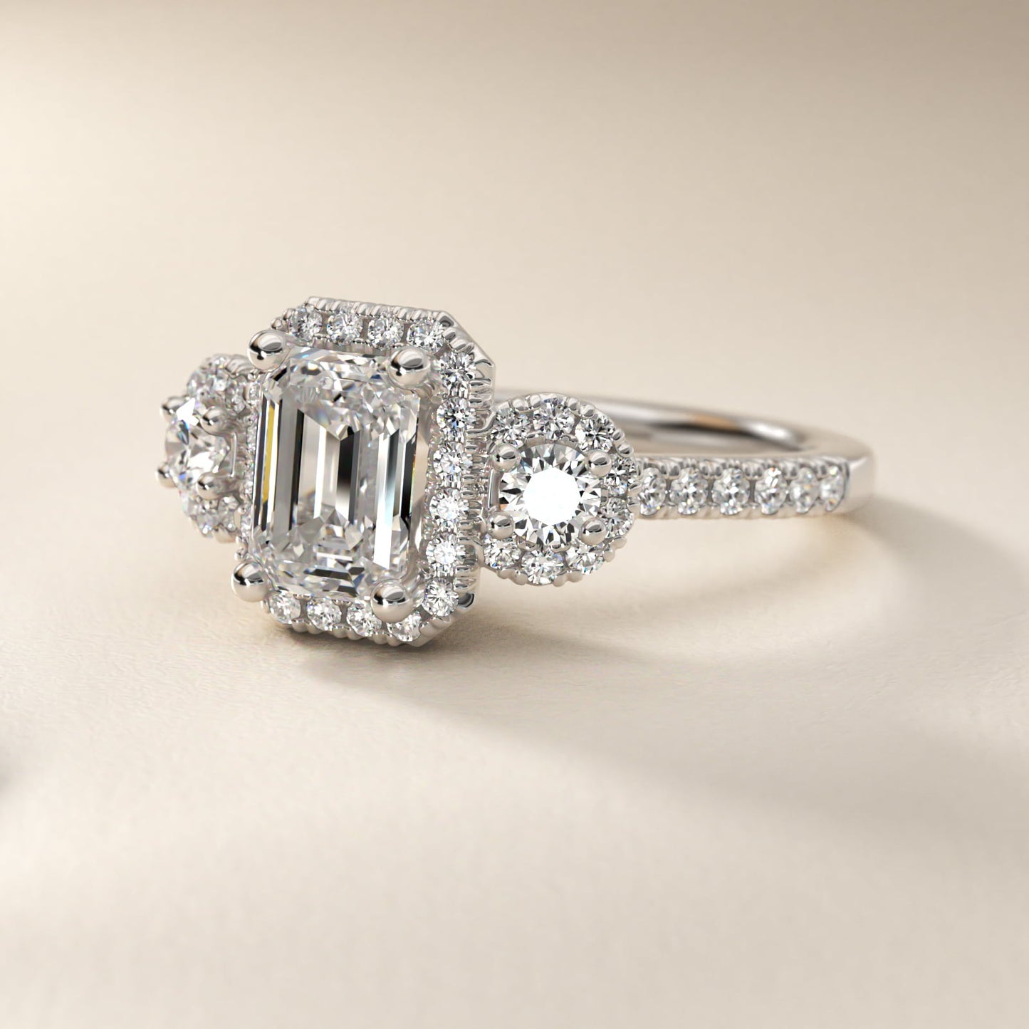 Three-Stone Halo Diamond Engagement Ring in Platinum - Emerald Center