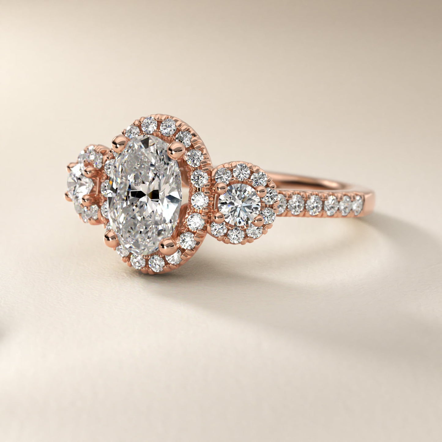 Three-Stone Halo Diamond Engagement Ring in 14k Rose Gold - Oval Center
