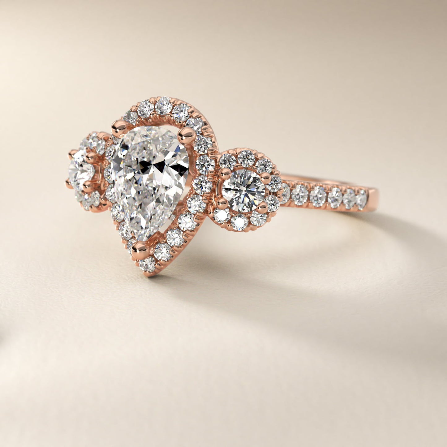 Three-Stone Halo Diamond Engagement Ring in 14k Rose Gold - Pear Center