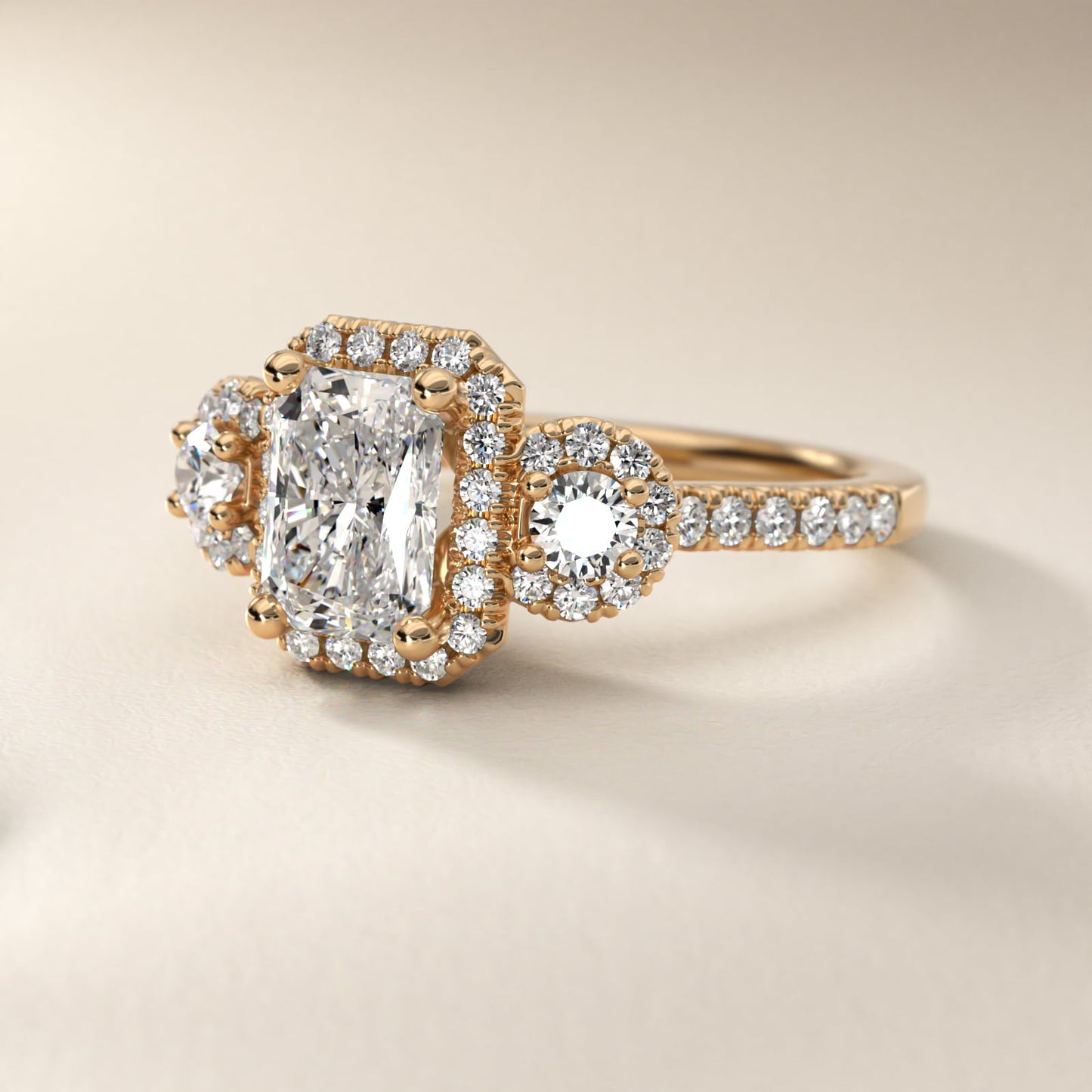 Three-Stone Halo Diamond Engagement Ring in 14k Yellow Gold - Radiant Center