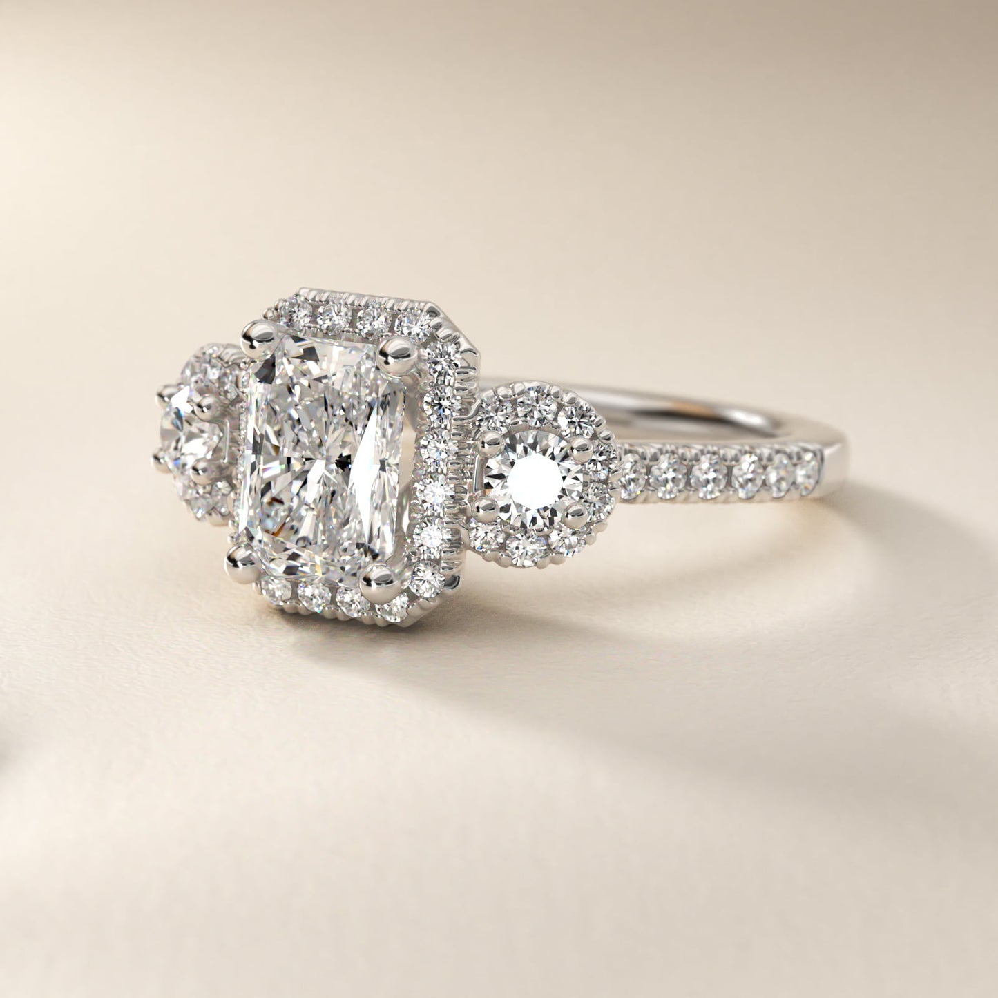 Three-Stone Halo Diamond Engagement Ring in Platinum - Radiant Center