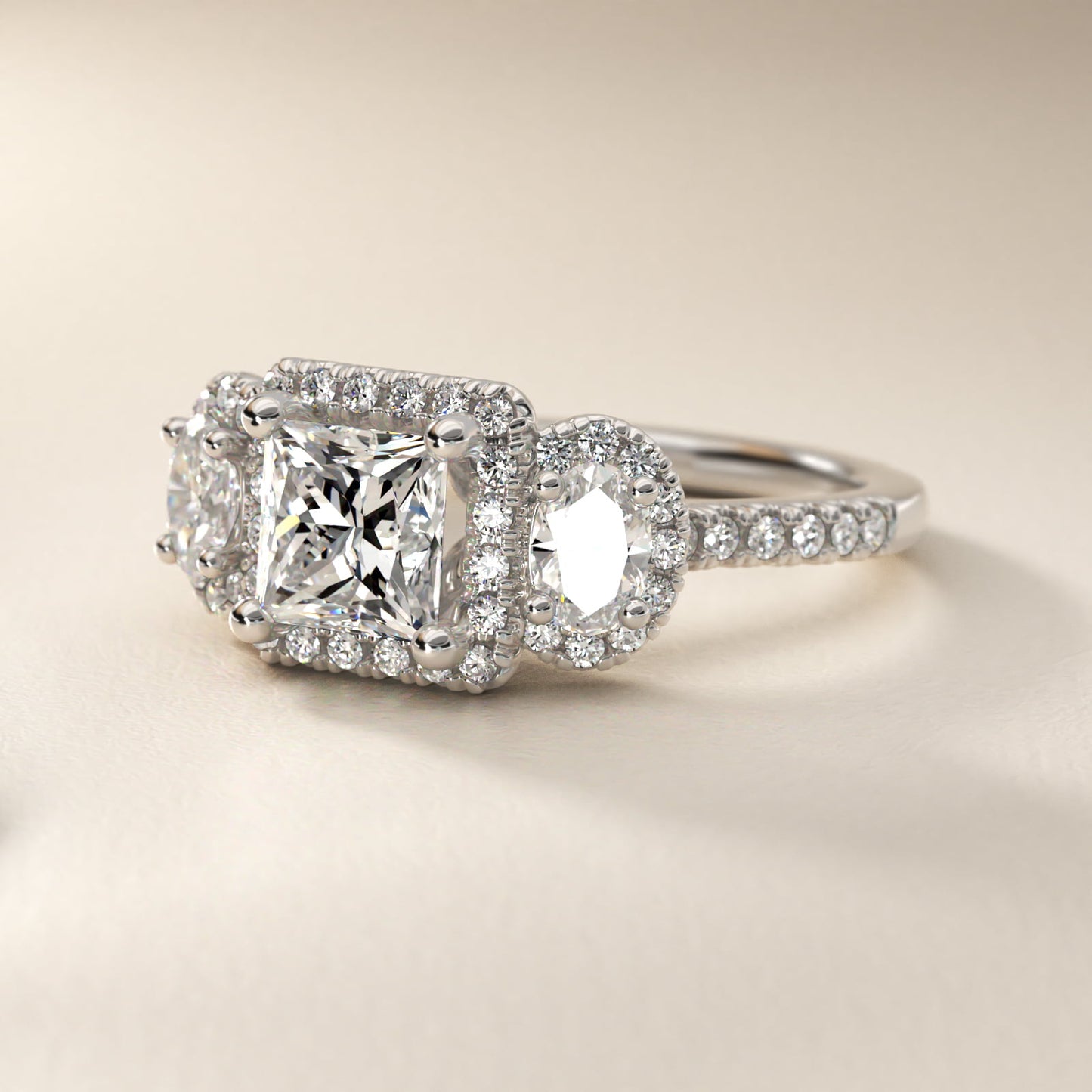 Three-Stone Oval Halo Diamond Engagement Ring in Platinum - Princess Center