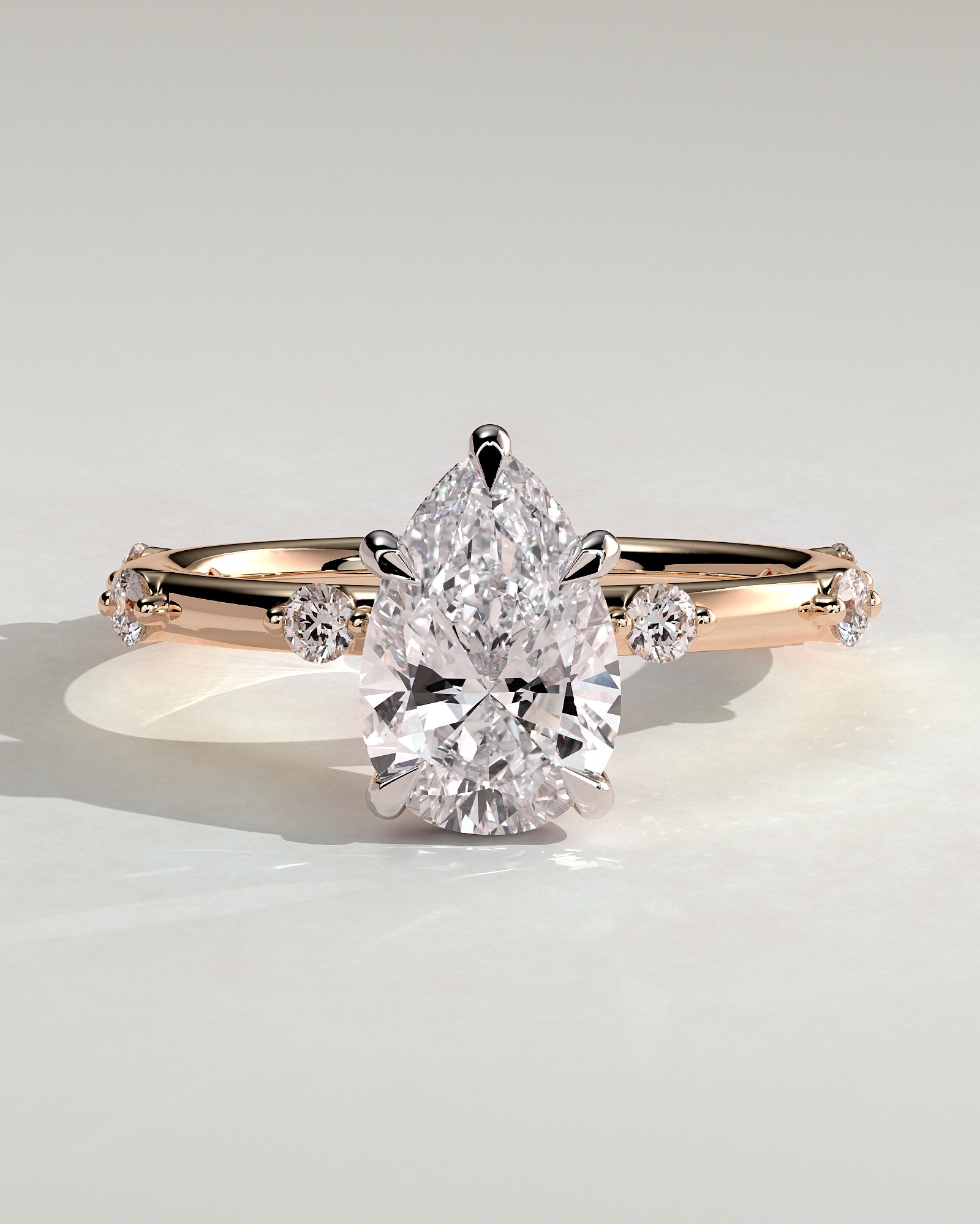 Amora - Pear Claw Solitaire with 6 Spaced Round Accent Stones and Hidden Halo Engagement Ring - Rose Two-Tone - Rose Two-Tone 2ct