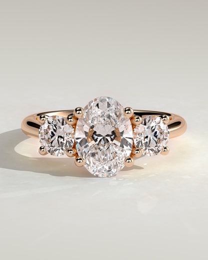 Grace - Oval Claw Trilogy with Round Side Stones, Open Trellis Gallery and Tapered Band Engagement Ring - Rose Gold