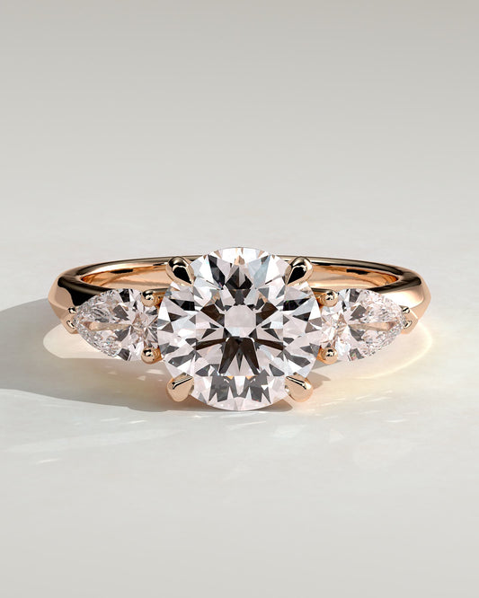Halle - Round Claw Trilogy with Pear Side Stones and Knife Edge Band Engagement Ring - Rose Gold
