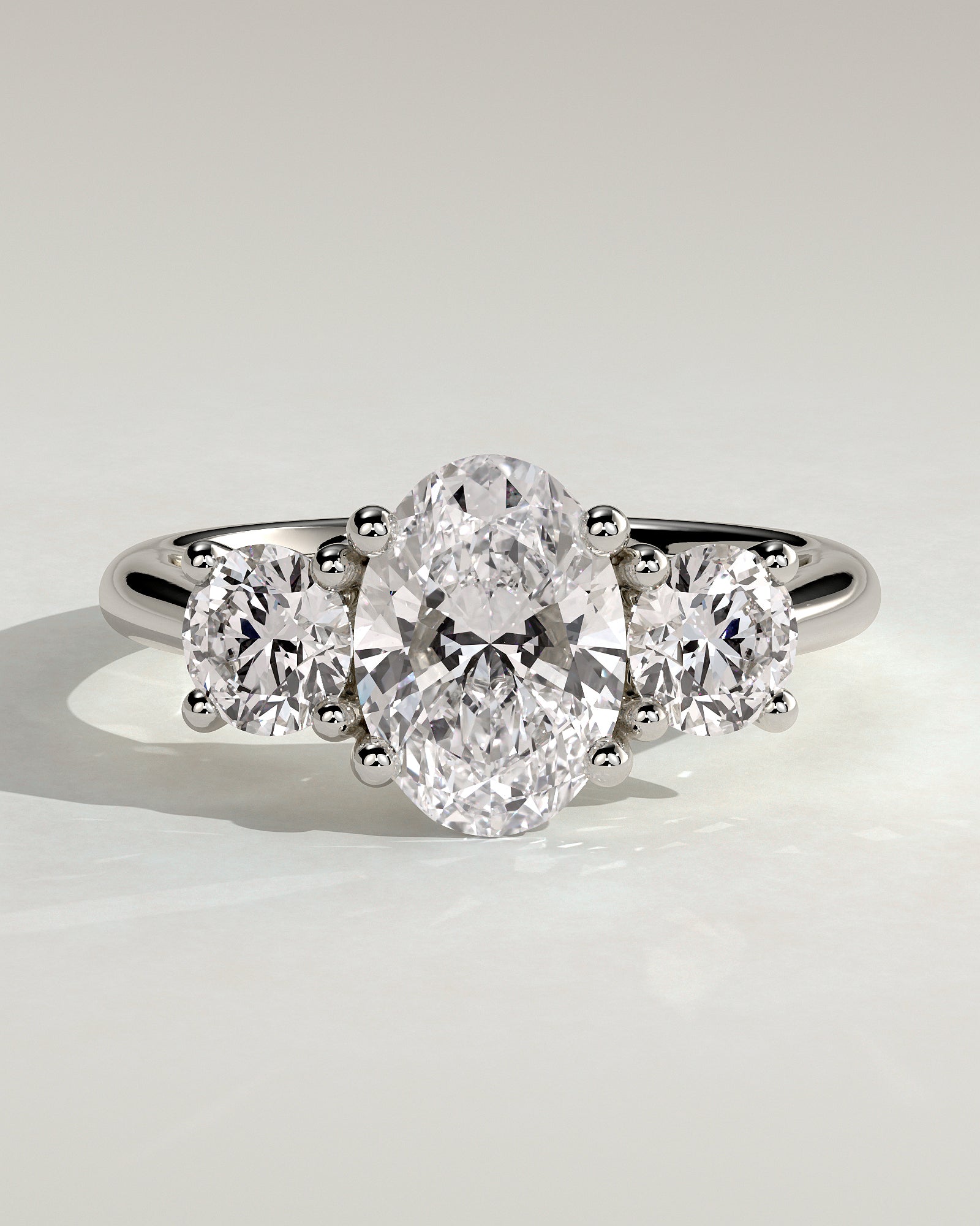 Grace - Oval Claw Trilogy with Round Side Stones, Open Trellis Gallery and Tapered Band Engagement Ring - Platinum - White Gold / Platinum 2ct