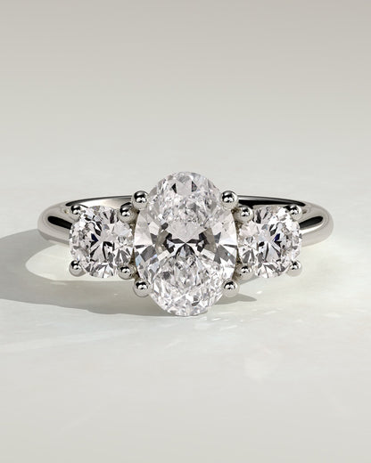 Grace - Oval Claw Trilogy with Round Side Stones, Open Trellis Gallery and Tapered Band Engagement Ring - Platinum