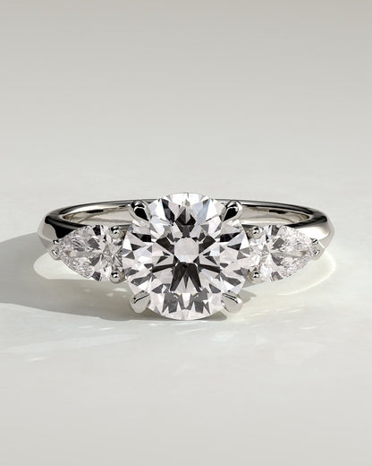 Halle - Round Claw Trilogy with Pear Side Stones and Knife Edge Band Engagement Ring - Platinum