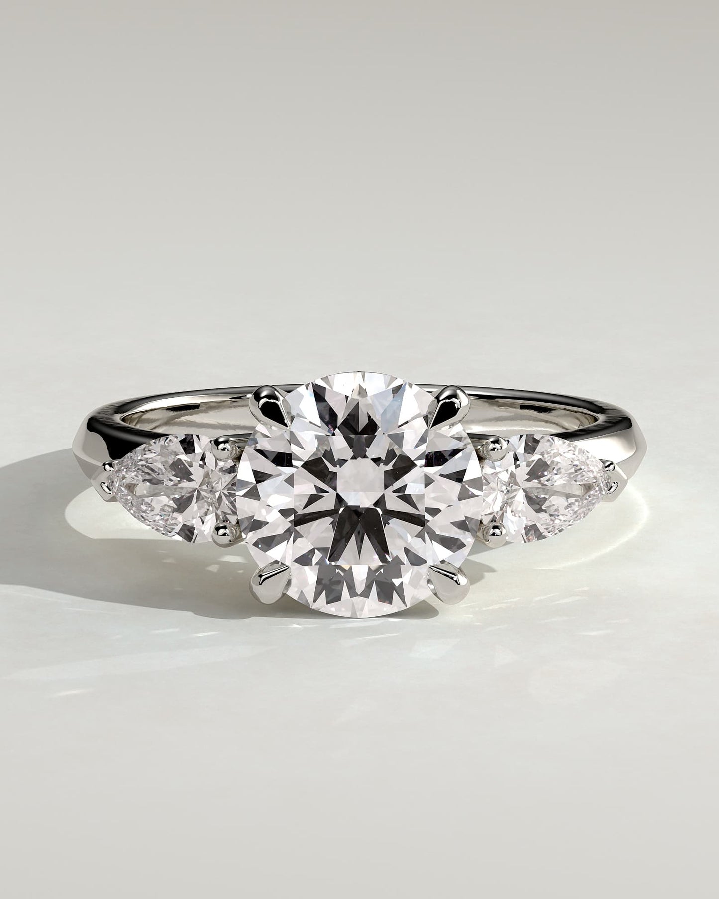 Halle - Round Claw Trilogy with Pear Side Stones and Knife Edge Band Engagement Ring - White Gold
