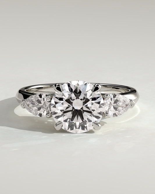 Halle - Round Claw Trilogy with Pear Side Stones and Knife Edge Band Engagement Ring - White Gold