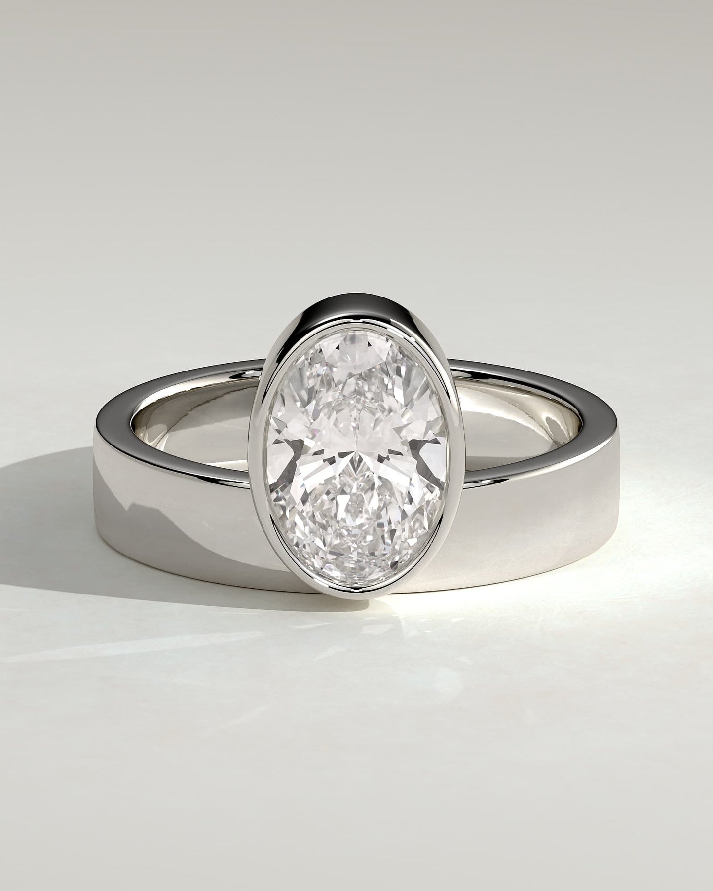Carmen - Oval Bezel Solitaire with Offset Setting and Flat Cigar Band Engagement Ring - White Gold