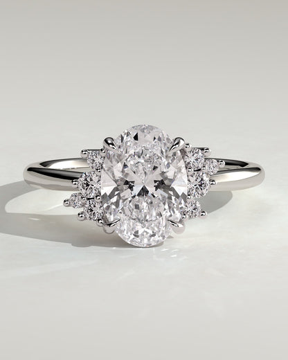 Esther - Oval Claw Solitaire with Clustered Round Opposing Shoulder Stones Engagement Ring - Platinum