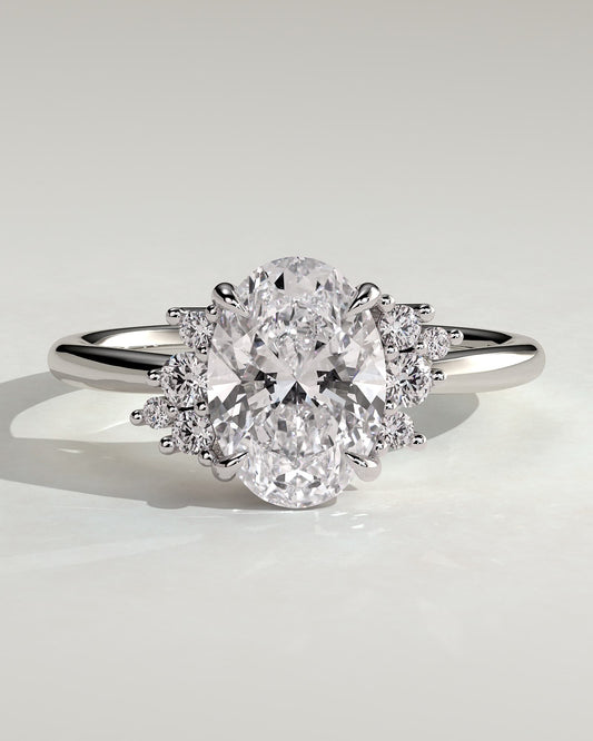 Esther - Oval Claw Solitaire with Clustered Round Opposing Shoulder Stones Engagement Ring - White Gold