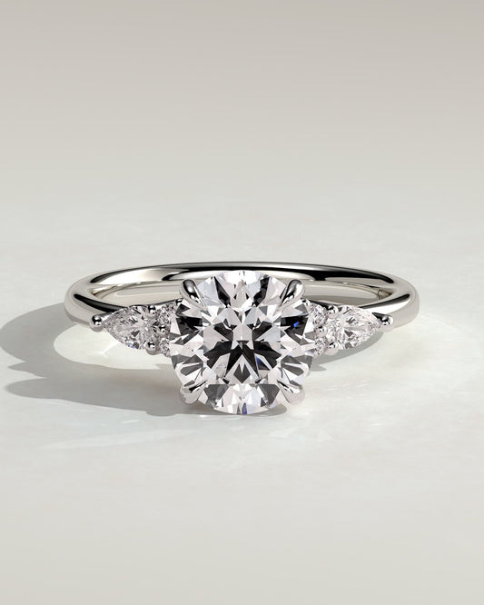 Maggie - Round Claw Solitaire with Pear Accents and Round Shoulder Stones Engagement Ring - Platinum