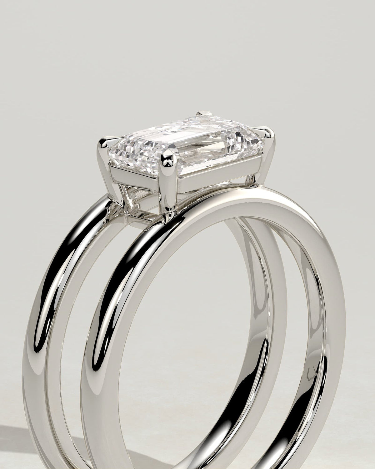 Devon - Emerald East West Claw Solitaire with Spaced Double Band Engagement Ring - Platinum