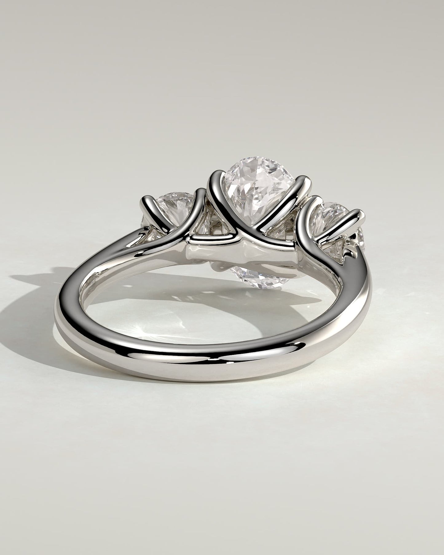 Grace - Oval Claw Trilogy with Round Side Stones, Open Trellis Gallery and Tapered Band Engagement Ring - White Gold