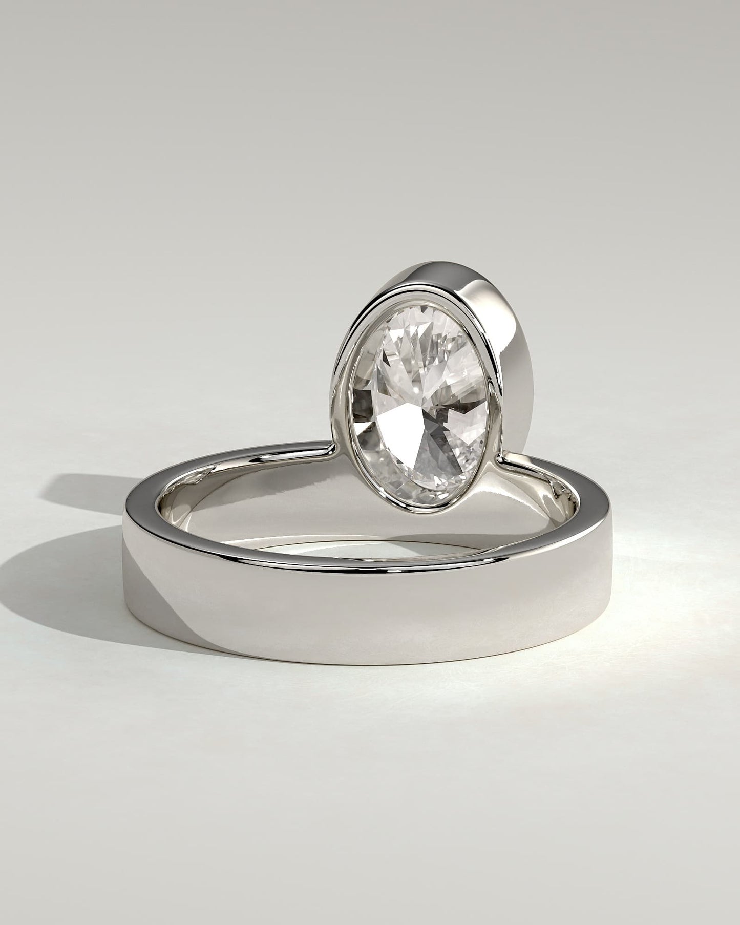 Carmen - Oval Bezel Solitaire with Offset Setting and Flat Cigar Band Engagement Ring - White Gold