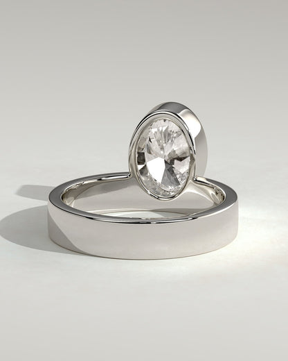 Carmen - Oval Bezel Solitaire with Offset Setting and Flat Cigar Band Engagement Ring - White Gold