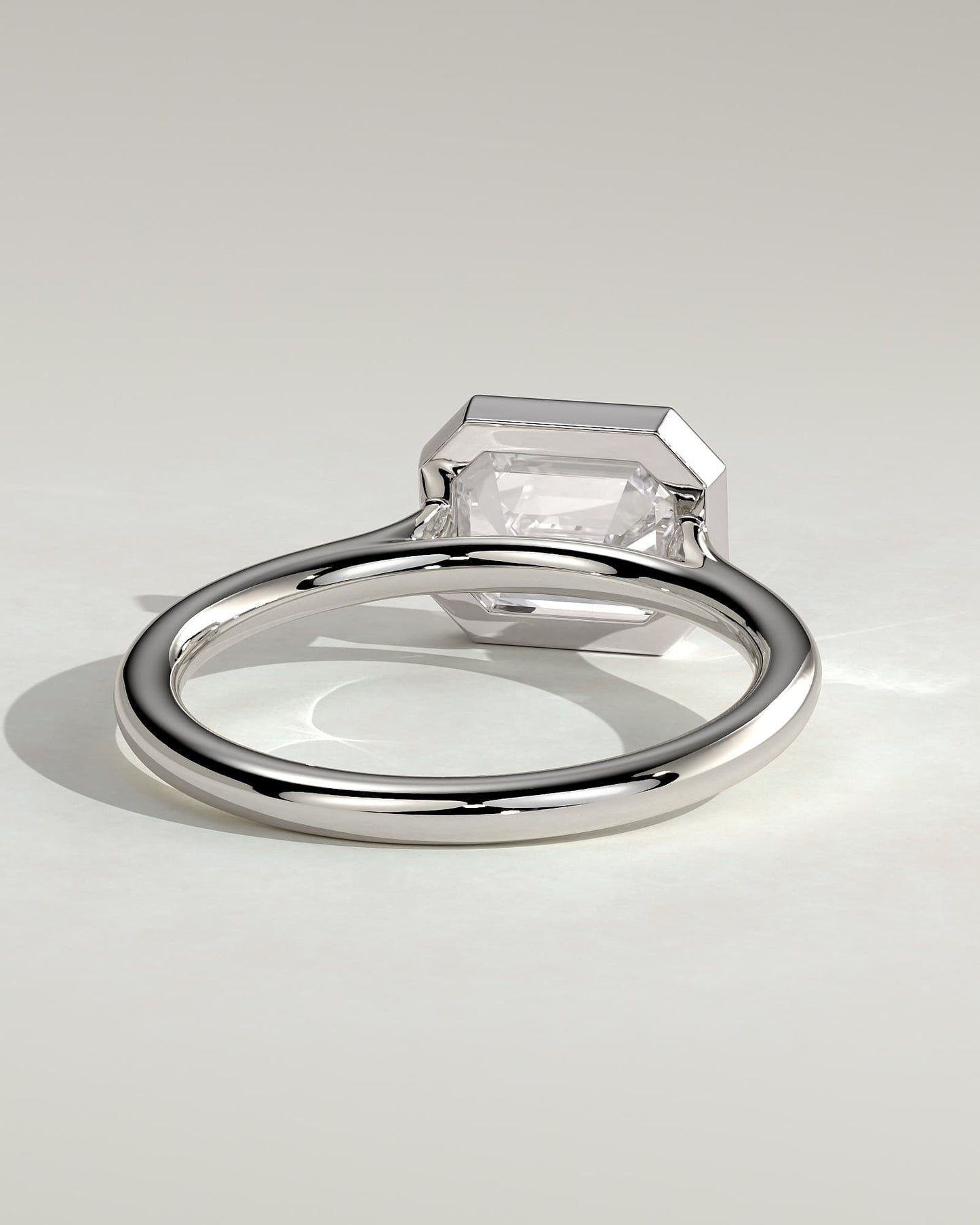 Olive - Statement Emerald East West Bezel Solitaire with Open Cathedral High Setting Engagement Ring - White Gold