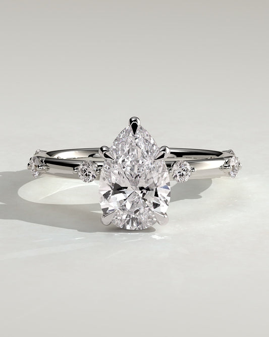 Amora - Pear Claw Solitaire with 6 Spaced Round Accent Stones and Hidden Halo Engagement Ring - White Gold