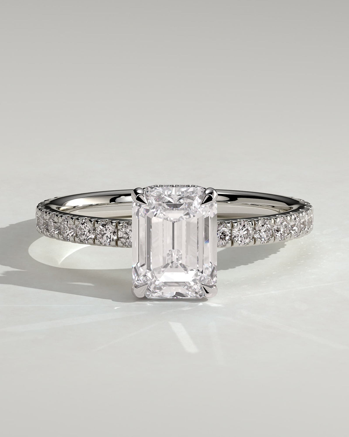 Eliana - Emerald Claw Solitaire with Wrap Around Hidden Halo and Pave Band Engagement Ring - White Gold