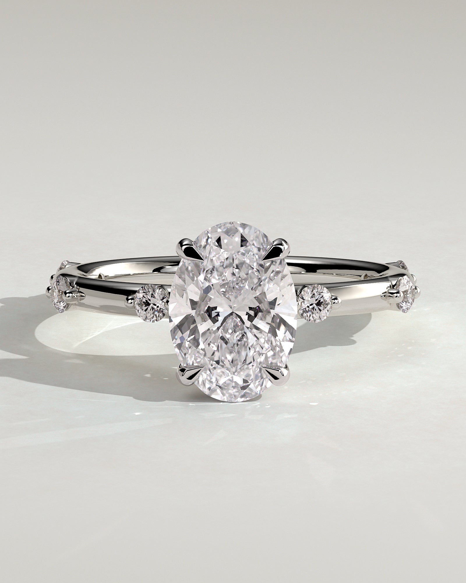 Elise - Oval Claw Solitaire with 6 Spaced Round Accent Stones and Hidden Halo Engagement Ring - Platinum - White Gold / Platinum 2ct