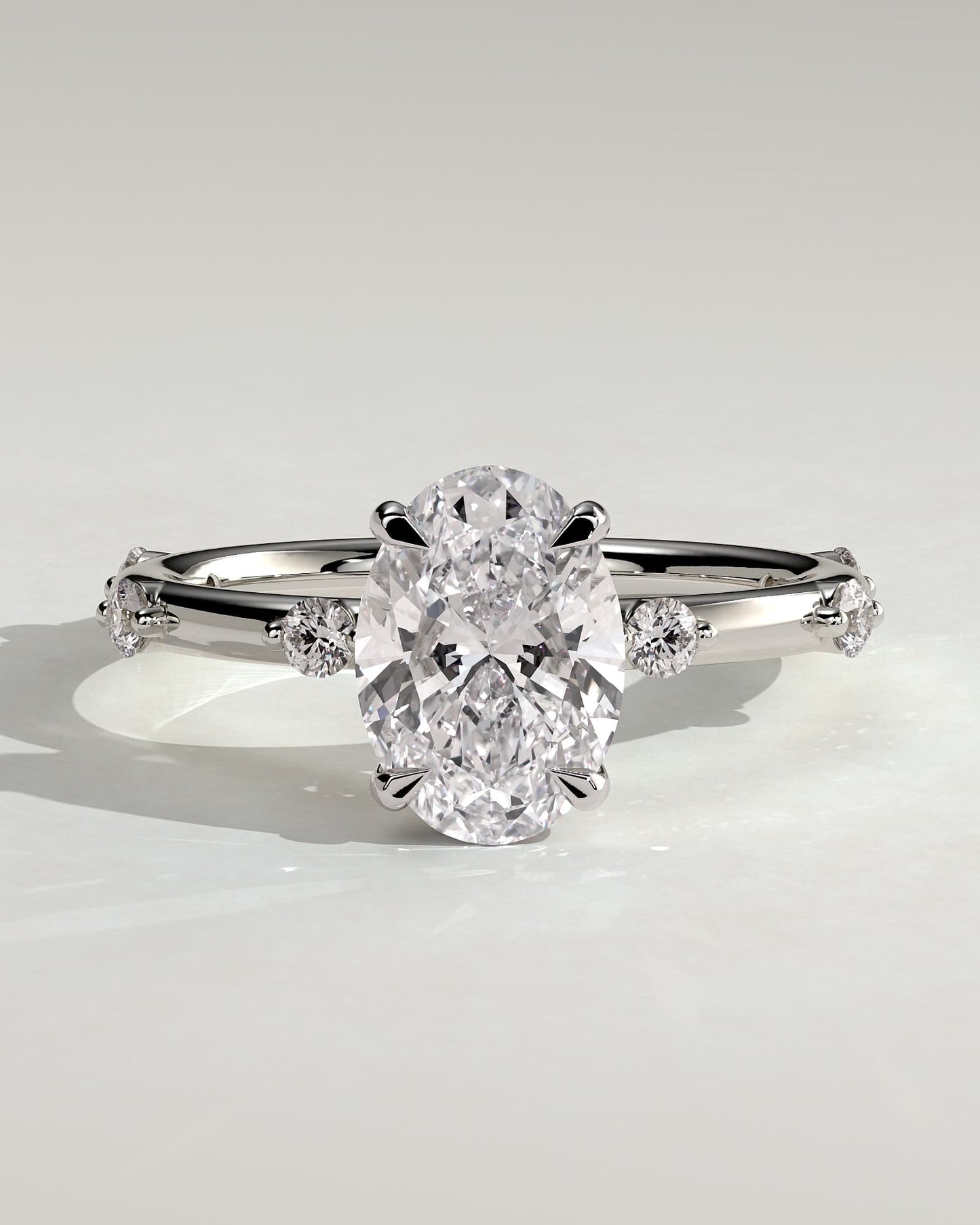 Elise - Oval Claw Solitaire with 6 Spaced Round Accent Stones and Hidden Halo Engagement Ring - White Gold