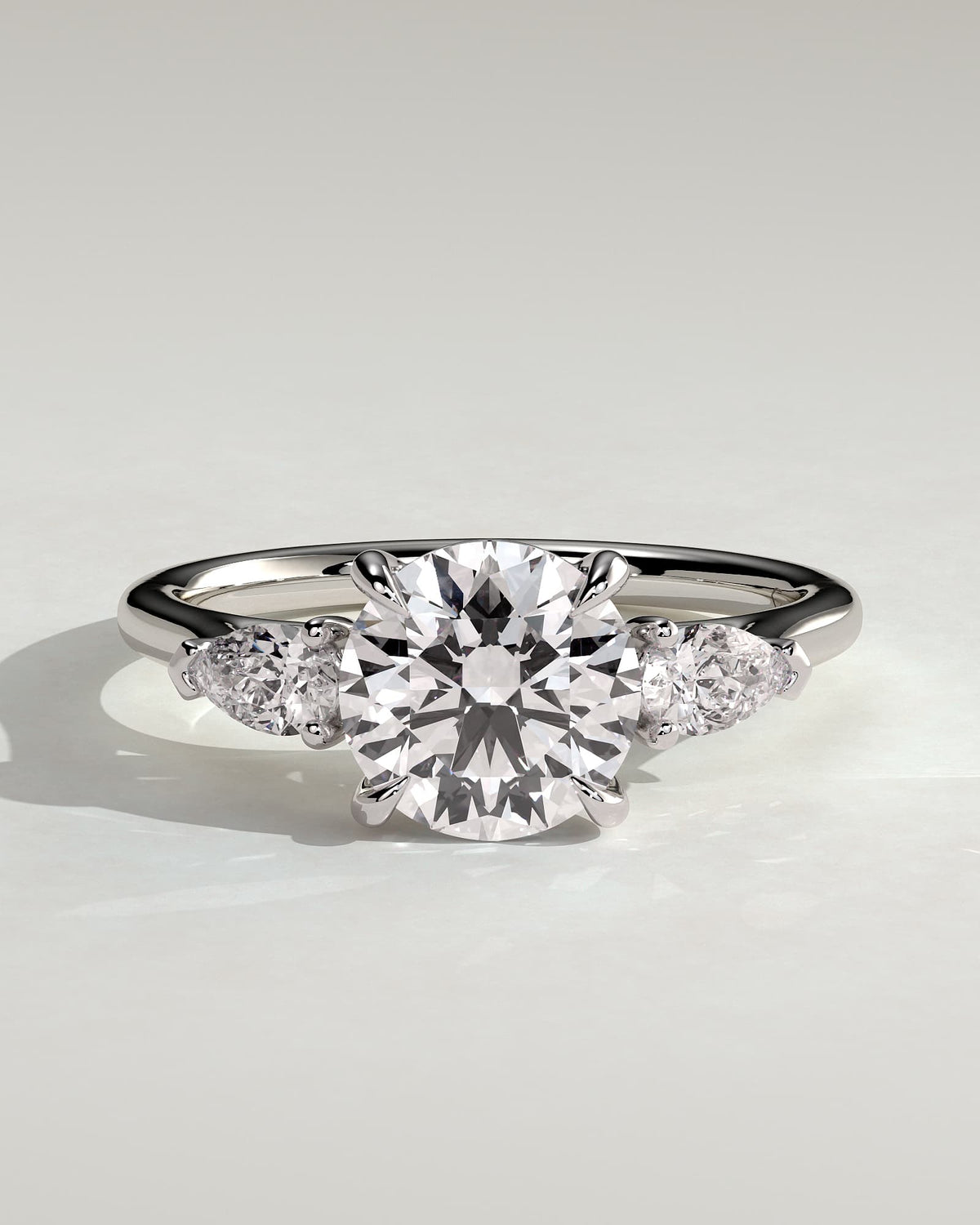 Arya - Round Claw Trilogy with Pear Side Stones and Cathedral Setting Engagement Ring - White Gold