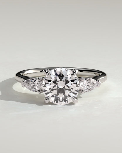 Arya - Round Claw Trilogy with Pear Side Stones and Cathedral Setting Engagement Ring - White Gold