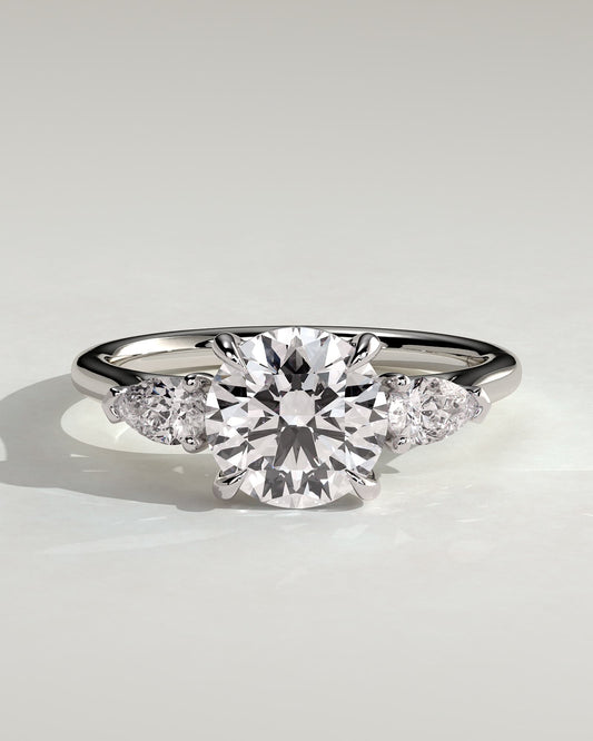Arya - Round Claw Trilogy with Pear Side Stones and Cathedral Setting Engagement Ring - White Gold