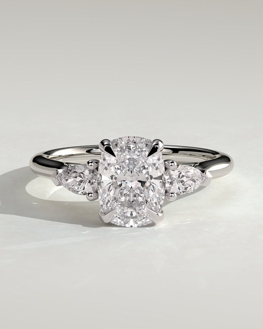 Cataleya - Elongated Cushion Claw Trilogy with Pear Side Stones and Cathedral Setting Engagement Ring - Platinum