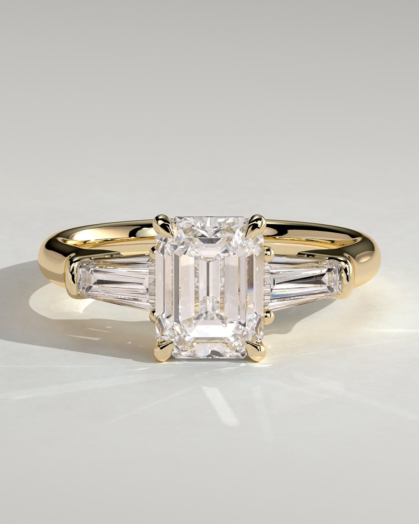 Bridget - Emerald Claw Trilogy with Tapered Baguette Side Stones and Cathedral Setting Engagement Ring - Yellow Gold