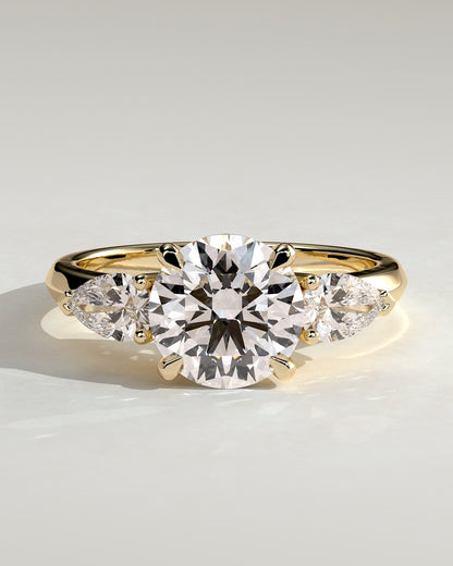 Halle - Round Claw Trilogy with Pear Side Stones and Knife Edge Band Engagement Ring - Yellow Gold