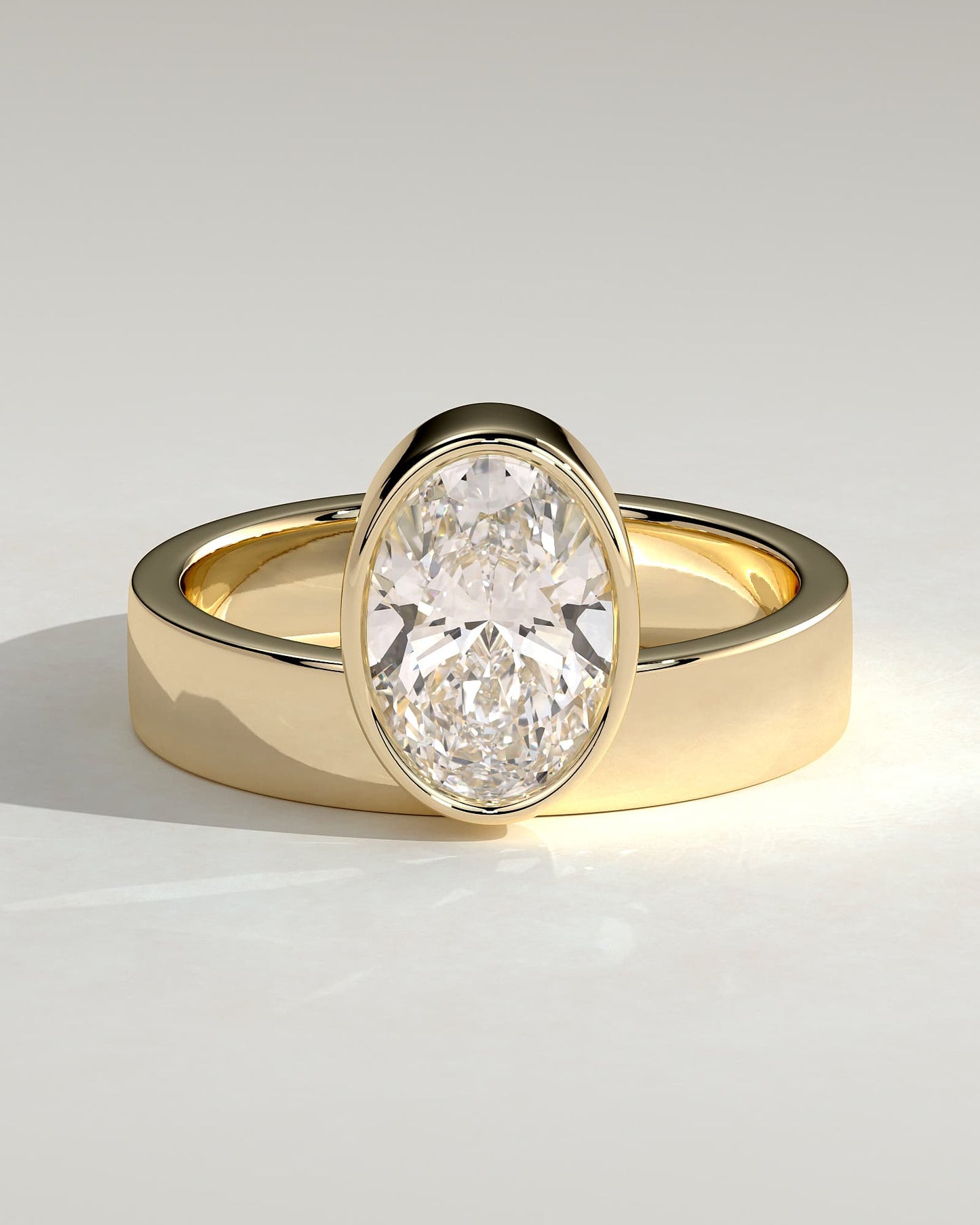 Carmen - Oval Bezel Solitaire with Offset Setting and Flat Cigar Band Engagement Ring - Yellow Gold