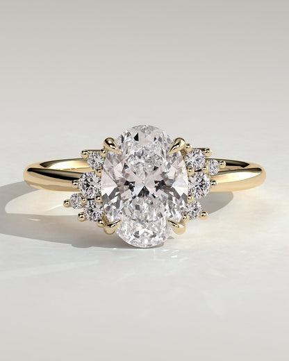 Esther - Oval Claw Solitaire with Clustered Round Opposing Shoulder Stones Engagement Ring - Yellow Gold