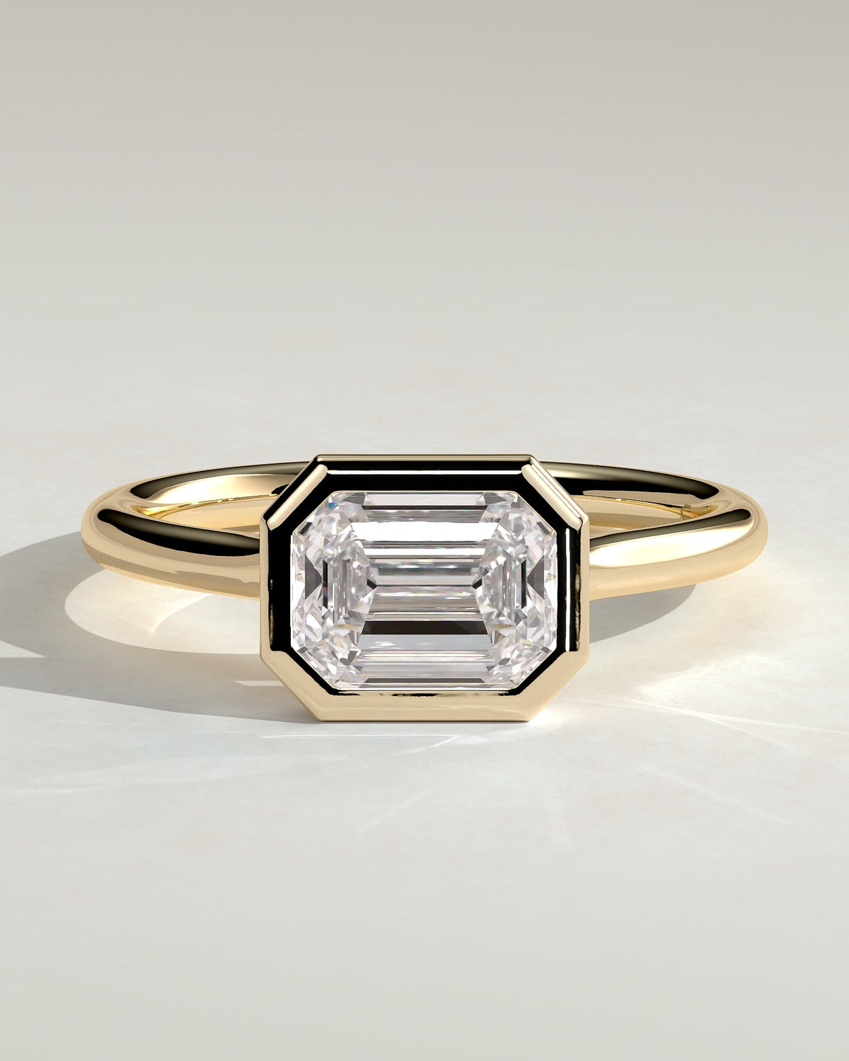 Olive - Statement Emerald East West Bezel Solitaire with Open Cathedral High Setting Engagement Ring - Yellow Gold