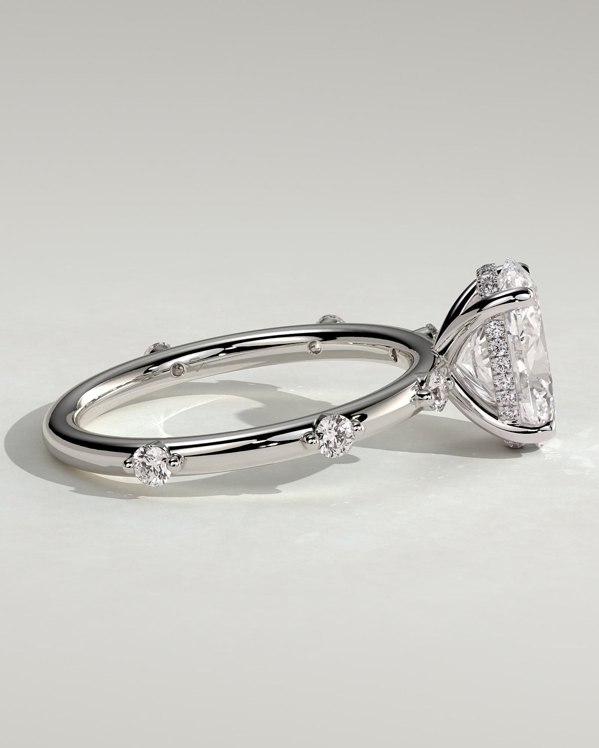 Elise - Oval Claw Solitaire with 6 Spaced Round Accent Stones and Hidden Halo Engagement Ring - White Gold