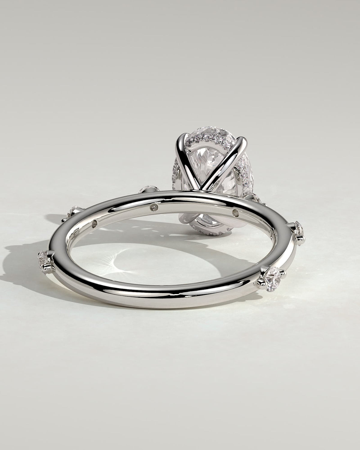 Elise - Oval Claw Solitaire with 6 Spaced Round Accent Stones and Hidden Halo Engagement Ring - White Gold